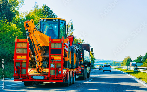 Truck trailer transporter with hauler carrying tractor road Slovenia reflex