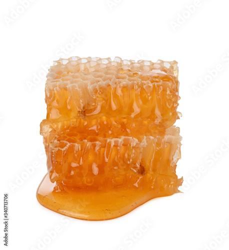 Honeycomb isolated single piece with liquid honey on white background