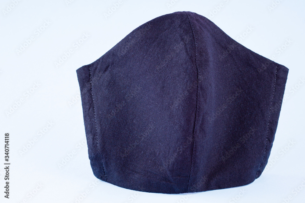 Protective mask on a pastel background. Anti-virus mask made of cotton. Black face mask during a virus COVID-19. Handmade face mask on blue background Protective mask on a pastel background. Anti-virus mask made of cotton. Black face mask during a virus COVID-19. Handmade face mask on blue background