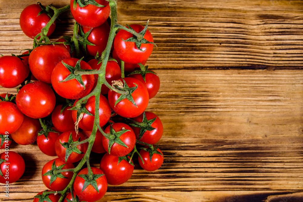 Heap of small cherry tomatoes on wooden table. Top view Heap of small cherry tomatoes on wooden table. Top view