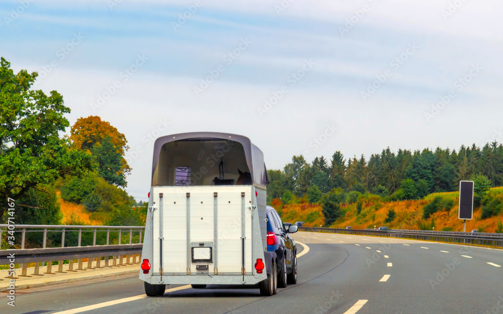 Car with horse trailer in road in Switzerland reflex Car with horse trailer in road in Switzerland reflex