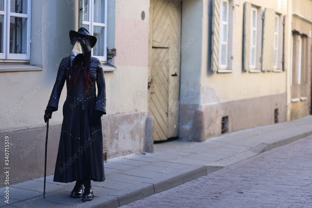Costume plague doctor in the city streets