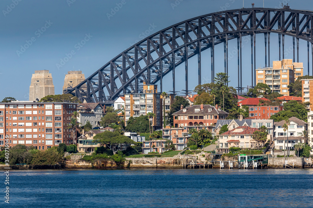 Sydney, Australia - 10th February 2020: A German photographer visiting Sydney in Australia, taking pictures of the skyline with the Harbour Bridge during a cloudy but warm day in summer.
