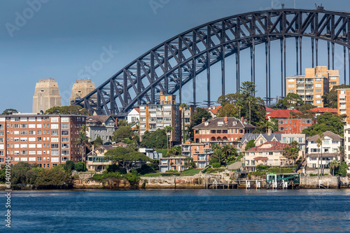 Sydney, Australia - 10th February 2020: A German photographer visiting Sydney in Australia, taking pictures of the skyline with the Harbour Bridge during a cloudy but warm day in summer. © ms_pics_and_more