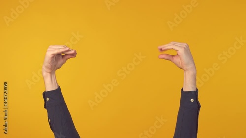 Man hands showing bla bla gesture over yellow background. Two hands sign photo