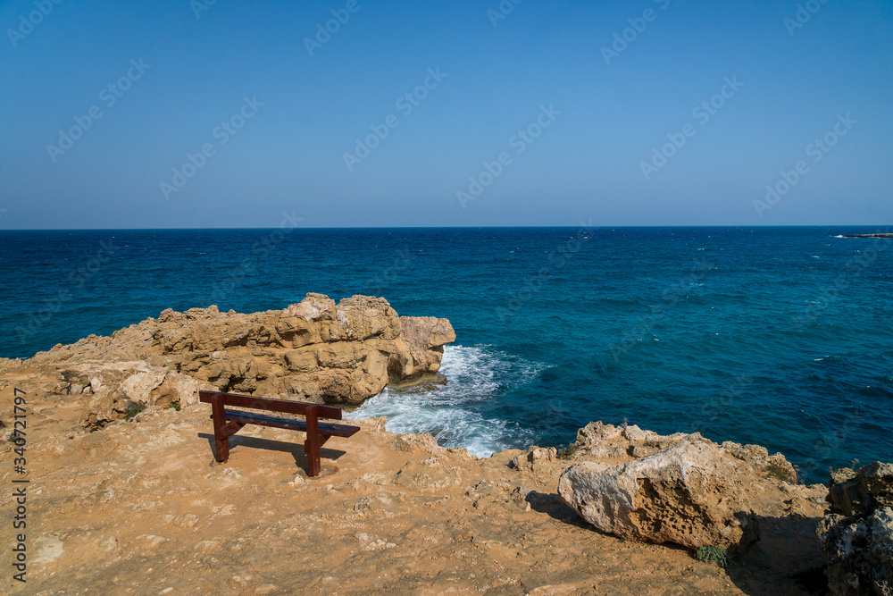 bench and sea and rocks. Cape Greco National Forest Park.