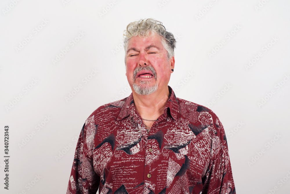 Negative human expressions and attitude. Angry dissatisfied male has disgusting expression as sees something not appealing, frowns face, isolated over white background. Distaste and dislike Negative human expressions and attitude. Angry dissatisfied male has disgusting expression as sees something not appealing, frowns face, isolated over white background. Distaste and dislike