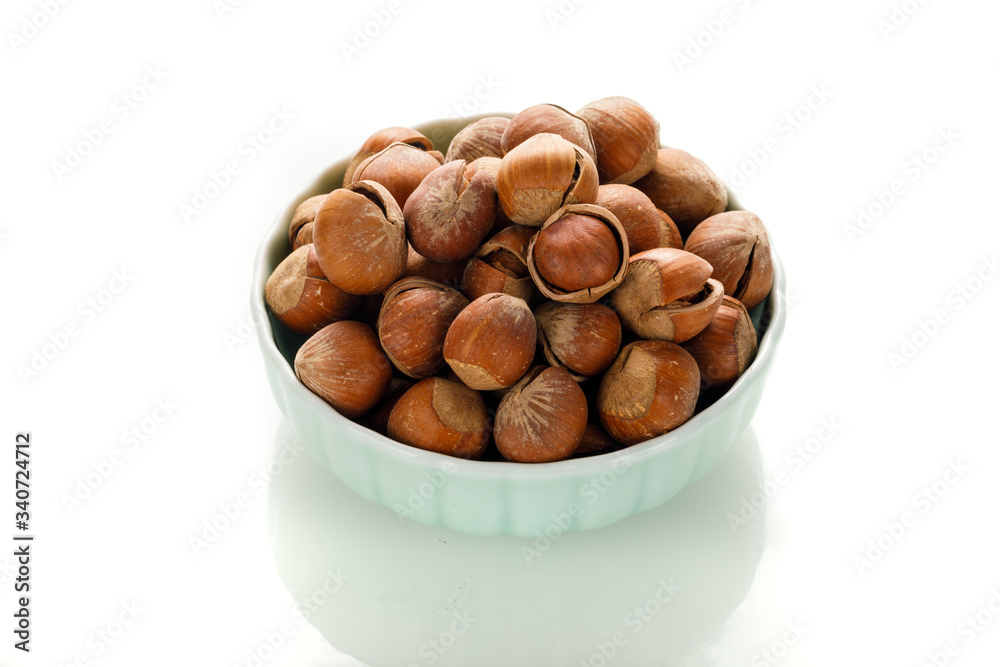 Hazelnut nuts on a white board