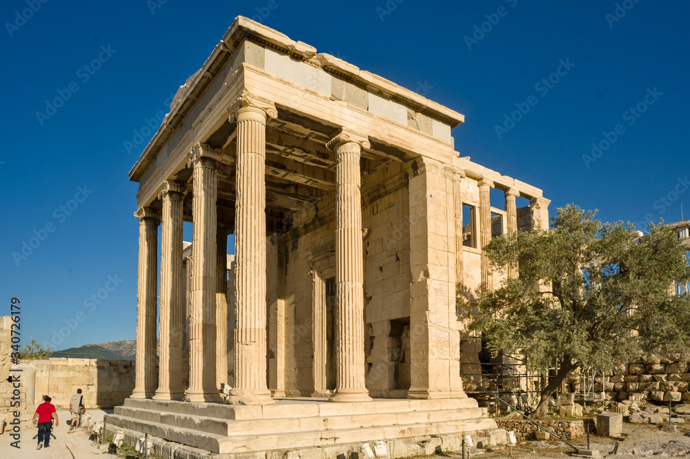 The Erechtheion is an ancient Greek temple on the north side of the Acropolis and The Legendary Olive Tree of the Pandroseion in Athens in Greece