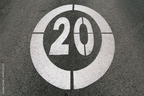 Traffic sign painted on the asphalt of the road marking the speed limit at 20 © txemag