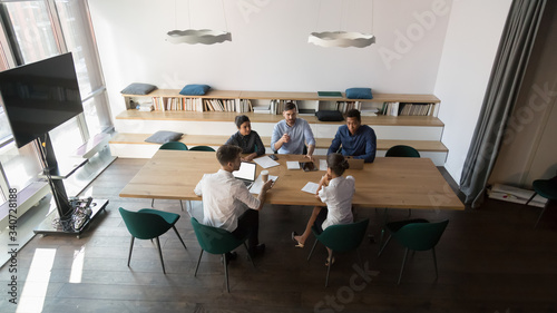 Photography View from above in spacious modern board room gathered multi-ethnic businesspeop