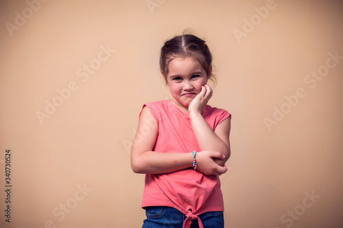 A portrait of kid girl feeling toothache. Children and healthcare concept