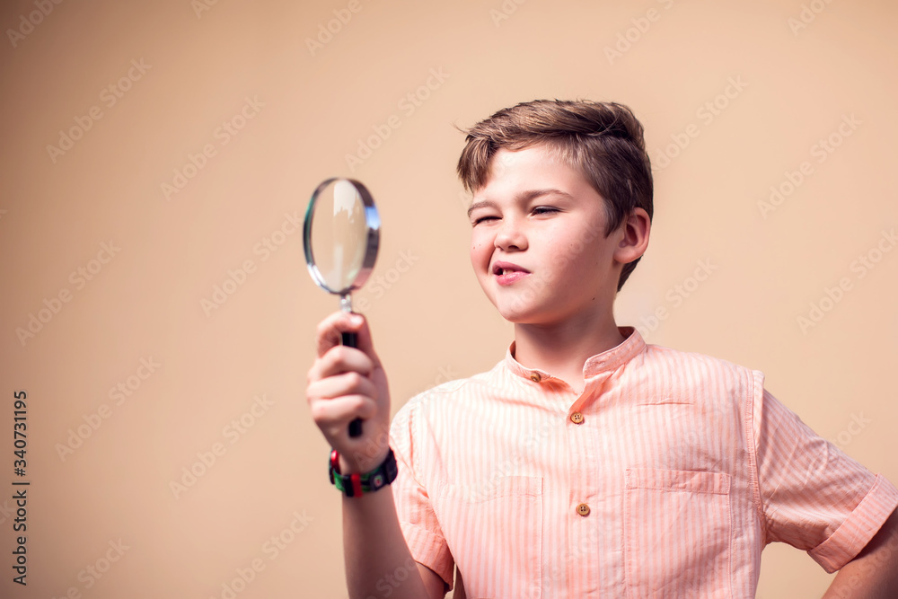 A portrait of kid boy holding magnifier. Children and knowlage concept A portrait of kid boy holding magnifier. Children and knowlage concept