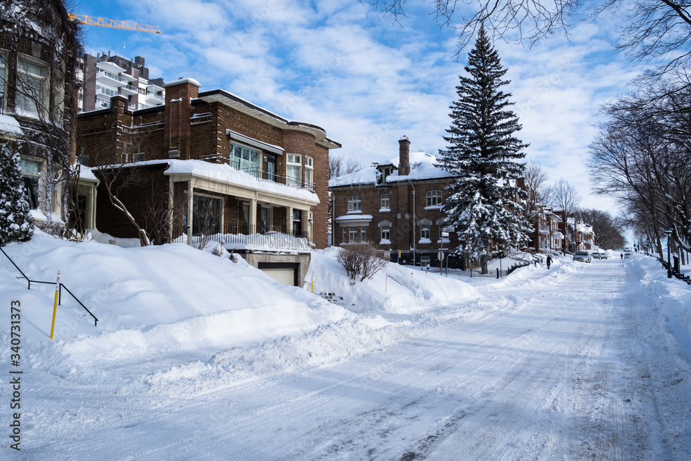 Houses and street covered with lot of snow in Canada