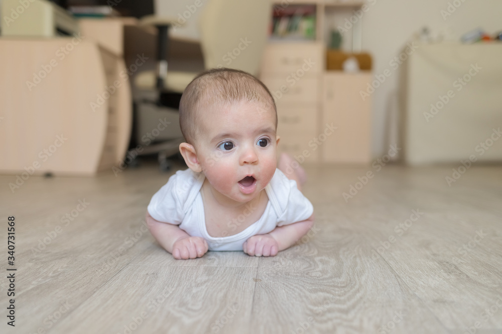 Newborn baby. A little boy in white clothes. Beautiful portrait of a toddler. Big-eyed baby. Newborn baby. A little boy in white clothes. Beautiful portrait of a toddler. Big-eyed baby.