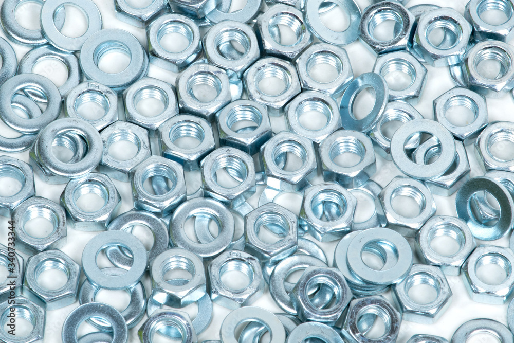 nuts and washers lie on a light background, close-up nuts and washers lie on a light background, close-up