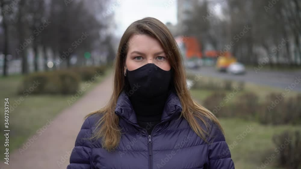 Woman in face protective mask in a city. Epidemic pandemic covid-19 coronavirus Woman in face protective mask in a city. Epidemic pandemic covid-19 coronavirus