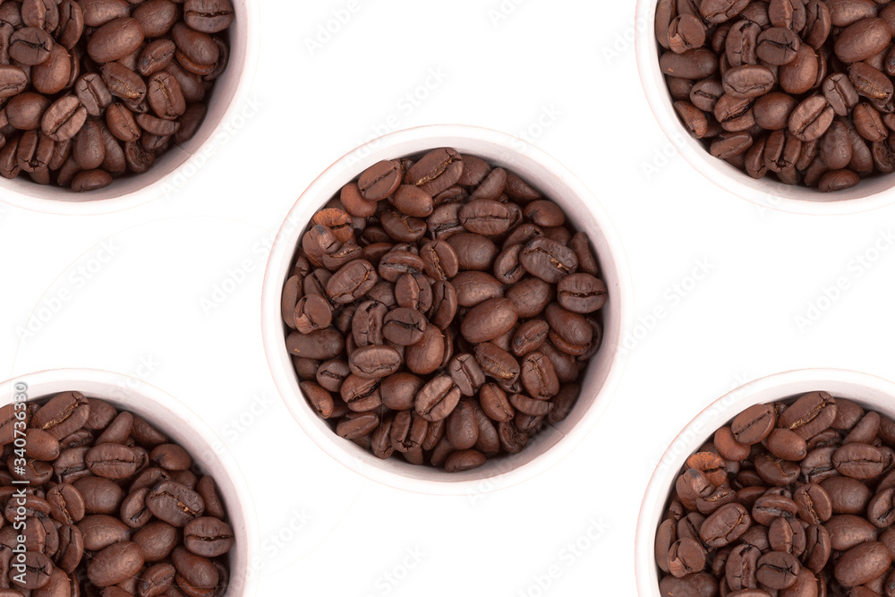 Five cups with coffee grains on a white background, cutout. Five cups with coffee grains on a white background, cutout.