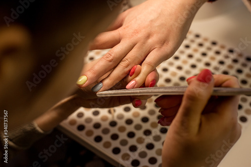 Women do manicures at home. Self-isolation manicure. Nail salon.