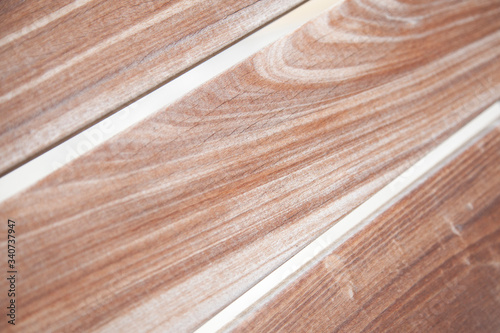 Close up view of grainy wooden bench planks. Wood details  pattern  cracks. Textured abstract background.