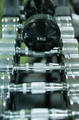 Fototapeta Naklejka Na Ścianę i Meble -  Sorted weights from five kilograms in the gym.
