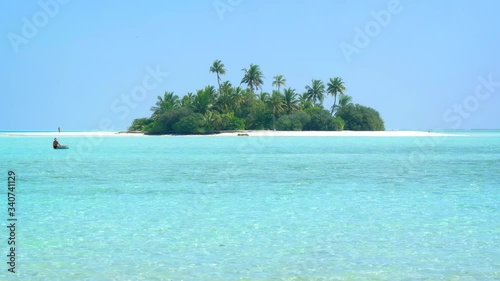 Palms over white sand and crystal clear waters of a tropical beach paradise photo