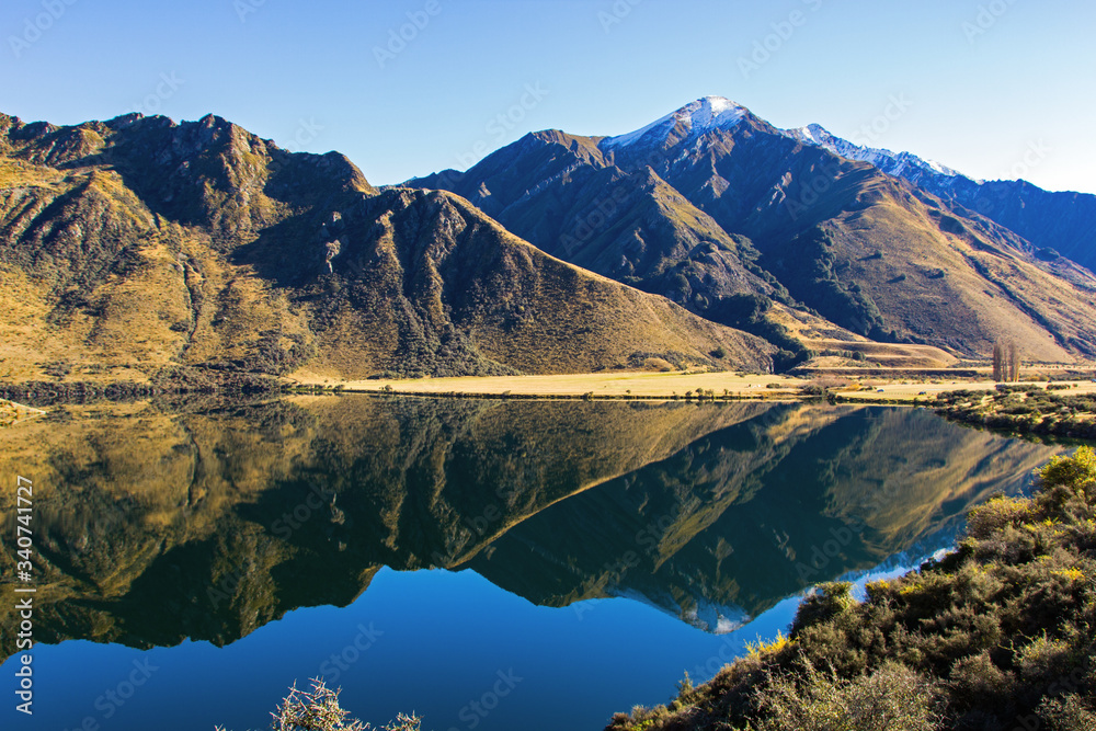 Moke Lake on the South Island of New Zealand. Photograph taken in autumn. Beautiful mountains and lake with reflections near Queenstown. Soft focus.