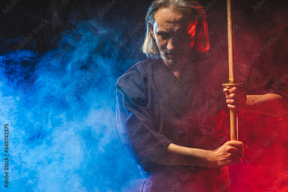 portrait of caucasian kendo fighter with bokuto, bamboo sword shinai