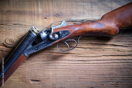 An old two-barrel hunting rifle on the table.