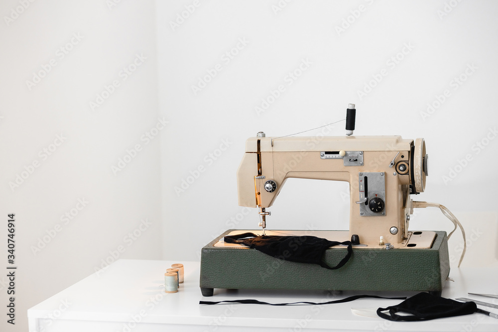 Beige sewing machine the process of sewing a protective medical mask at home is handmade