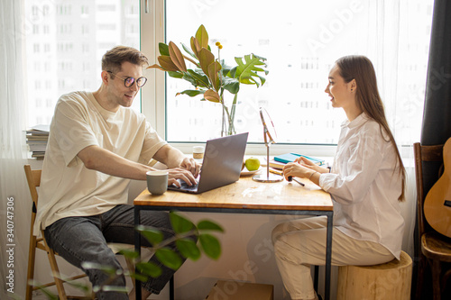 family concept. beautiful lady do make-up at morning while her husband work on laptop, he is at freelance. everybody busy with their own business