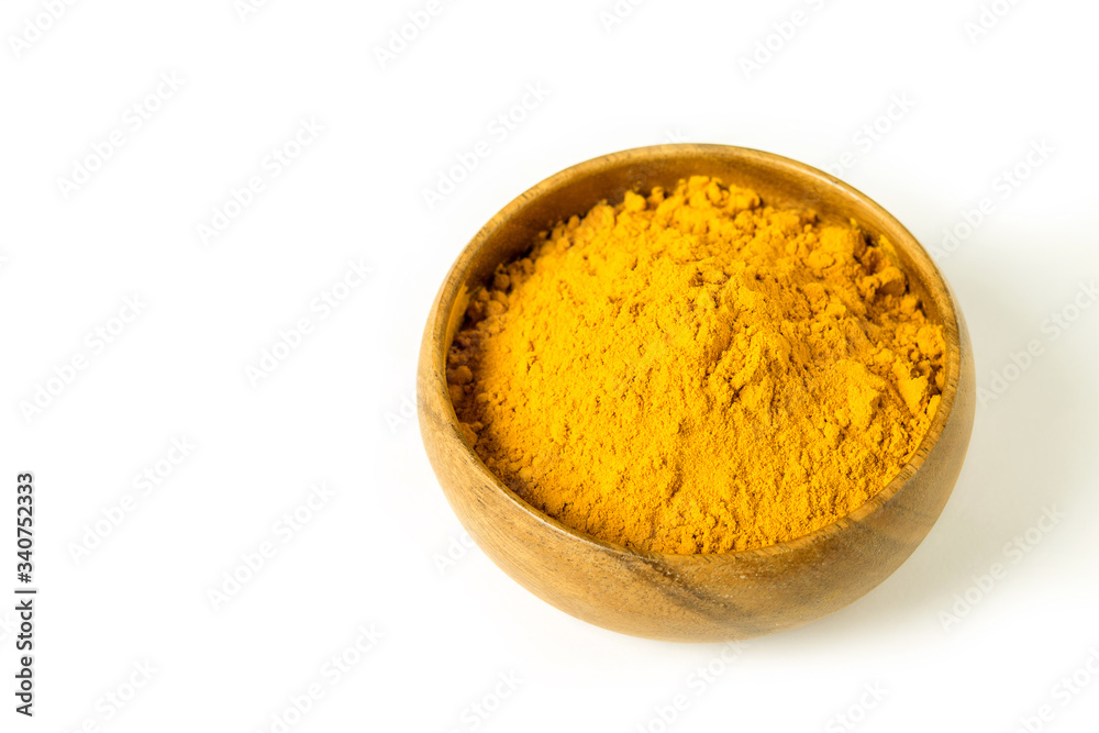 Turmeric powder in wooden bowl on the white background isolated closeup. Alternative medicine, healing spice, health care concept. Turmeric powder in wooden bowl on the white background isolated closeup. Alternative medicine, healing spice, health care concept.