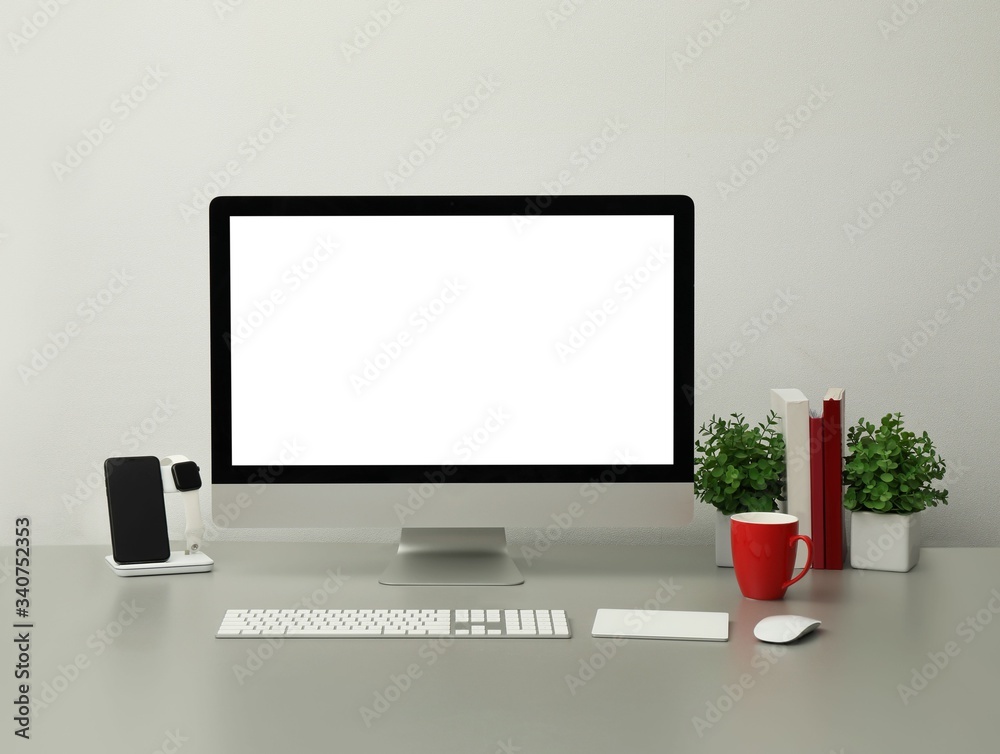Modern workplace with computer, charging devices and houseplants. Interior design Modern workplace with computer, charging devices and houseplants. Interior design