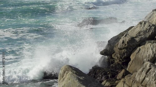 ocean wave crashes on rocks