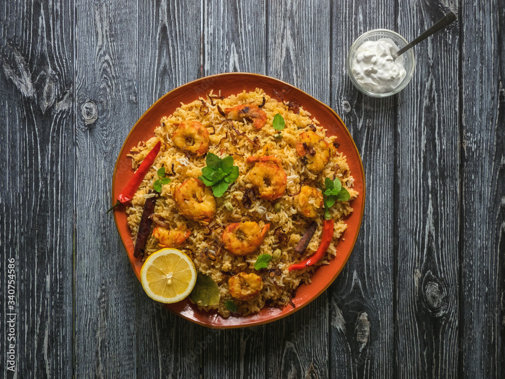 Indian Biryani with shrimp. Tasty and delicious prawns biryani, top view Indian Biryani with shrimp. Tasty and delicious prawns biryani, top view