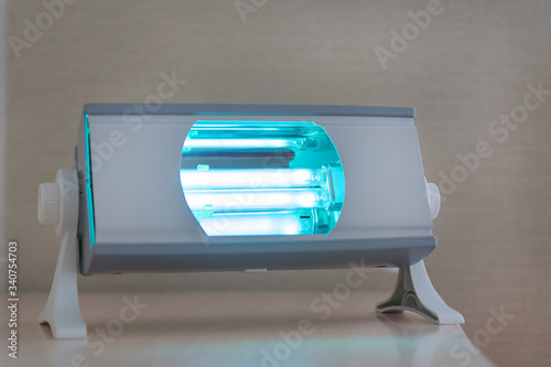 compact quartz lamp with blue light for home disinfection, family protection from bacteria, viruses and coronavirus pandemic, healthcare concept