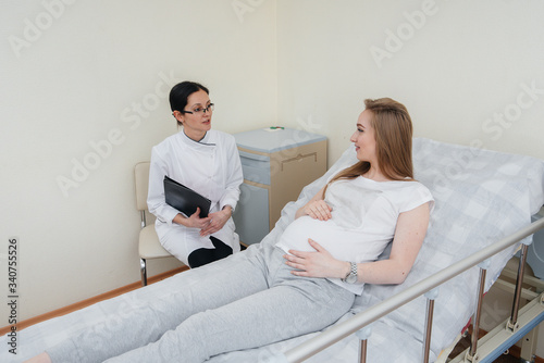 The doctor advises and serves a young pregnant girl in a medical clinic. Medical examination