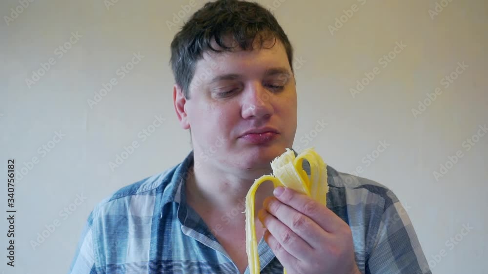 adult man who eats ripe banana with an appetite. adult man who eats ripe banana with an appetite.