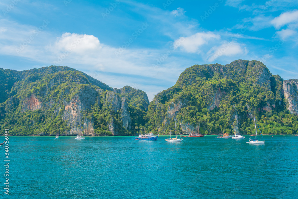 thailand islands with rocks and vegetation at the edge of the blue sea clean and blue sky and beautiful sunny day in southeast asia