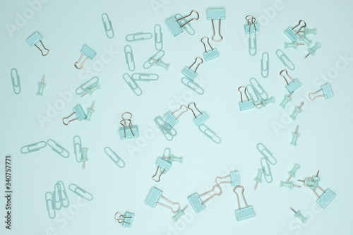 Office clips and binders on a turquoise background
