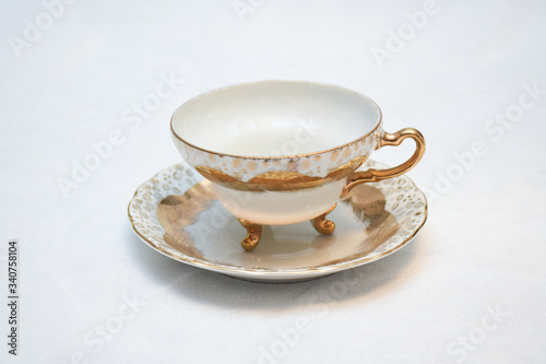 Mock up   design set of elegant and traditional teapot colorful white blue gold coffee cup   Tea cup on cup s plate beside the hot tea pot   design  drink-ware isolated on white background