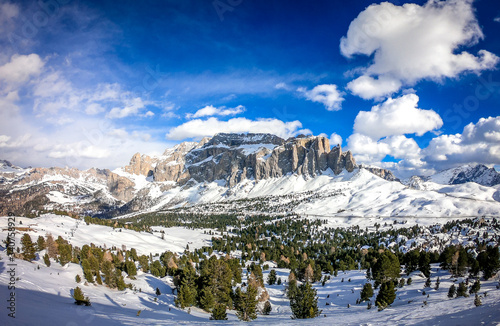 Landscape at a ski resort Campitello di Fassa Italy. Winter Dolomites and blue sky with clouds. photo