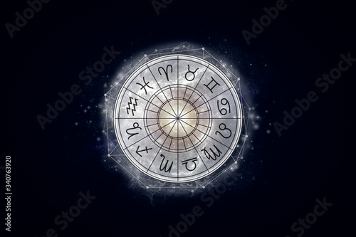 Foto Astrological circle with the signs of the zodiac on a background of the starry sky