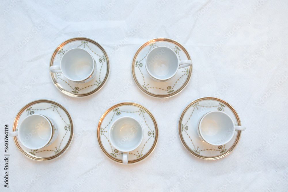 Mock up / design set of elegant and traditional teapot colorful white blue gold coffee cup & Tea cup on cup's plate beside the hot tea pot , design/ drink-ware isolated on white background Mock up / design set of elegant and traditional teapot colorful white blue gold coffee cup & Tea cup on cup's plate beside the hot tea pot , design/ drink-ware isolated on white background