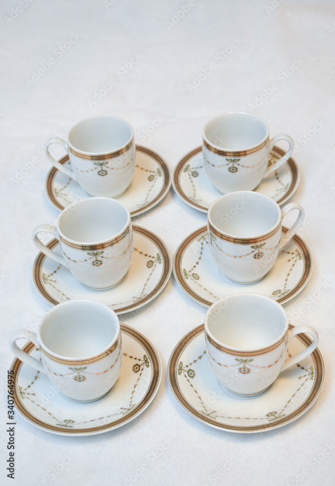 Mock up / design set of elegant and traditional teapot colorful white blue gold coffee cup & Tea cup on cup's plate beside the hot tea pot , design/ drink-ware isolated on white background Mock up / design set of elegant and traditional teapot colorful white blue gold coffee cup & Tea cup on cup's plate beside the hot tea pot , design/ drink-ware isolated on white background