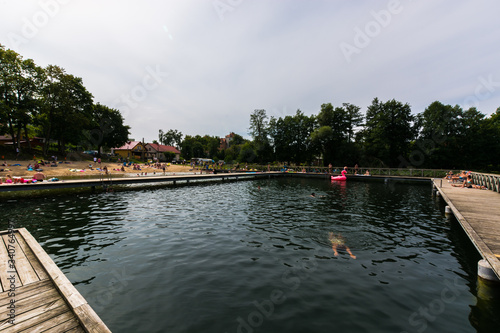 Fototapeta Naklejka Na Ścianę i Meble -  Pople relaxing at the lake next to Giżycko city, Mazury, Poland.