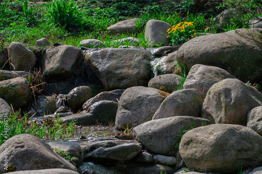 Czech brook flows between stones with small waterfall
Czech brook flows between stones with small waterfall