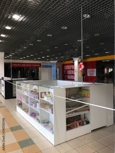 Kharkov, Ukraine, 11th april 2020: quarantined empty stores in the mall, tied with a white and red boundary tape, during the quarantine, wide shot © Анна Погорелая