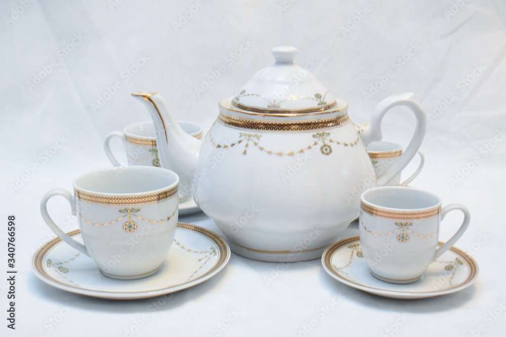 Mock up / design set of elegant and traditional teapot colorful white blue gold coffee cup & Tea cup on cup's plate beside the hot tea pot , design/ drink-ware isolated on white background Mock up / design set of elegant and traditional teapot colorful white blue gold coffee cup & Tea cup on cup's plate beside the hot tea pot , design/ drink-ware isolated on white background