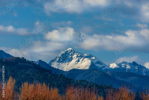 Mountains, woods and clouds above. View of Apennine with snow